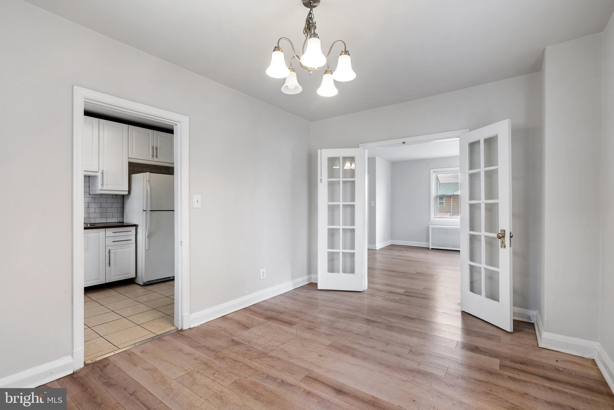 1617 Northwick Road Baltimore, MD 21218 - Photo 10 of 32 a view of empty room with wooden floor and window