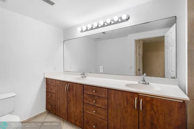a bathroom with a shower sink and mirror