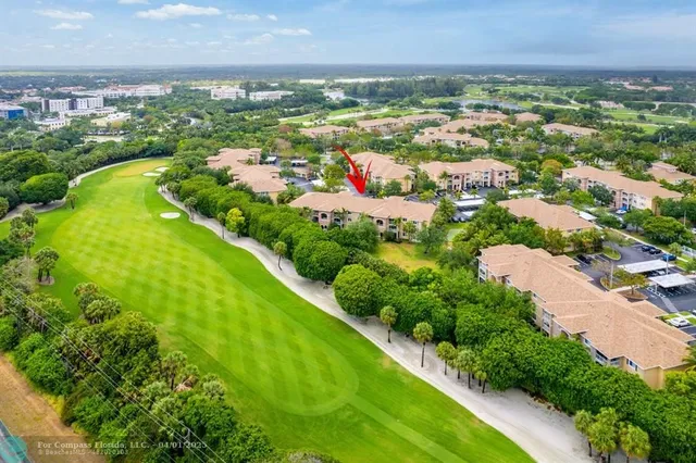 an aerial view of residential houses with outdoor space and swimming pool