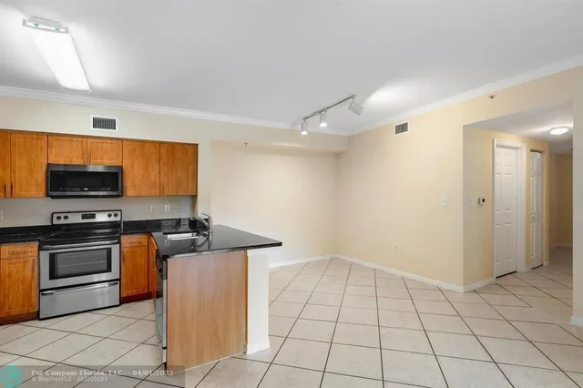 a kitchen with a stove a microwave and a counter top space