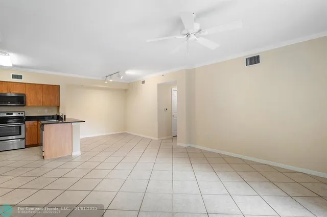 a view of a kitchen with a sink and a refrigerator