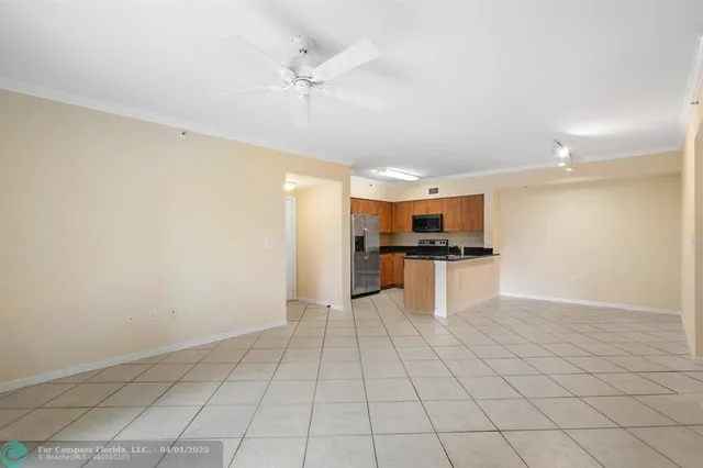 a view of kitchen with granite countertop cabinets