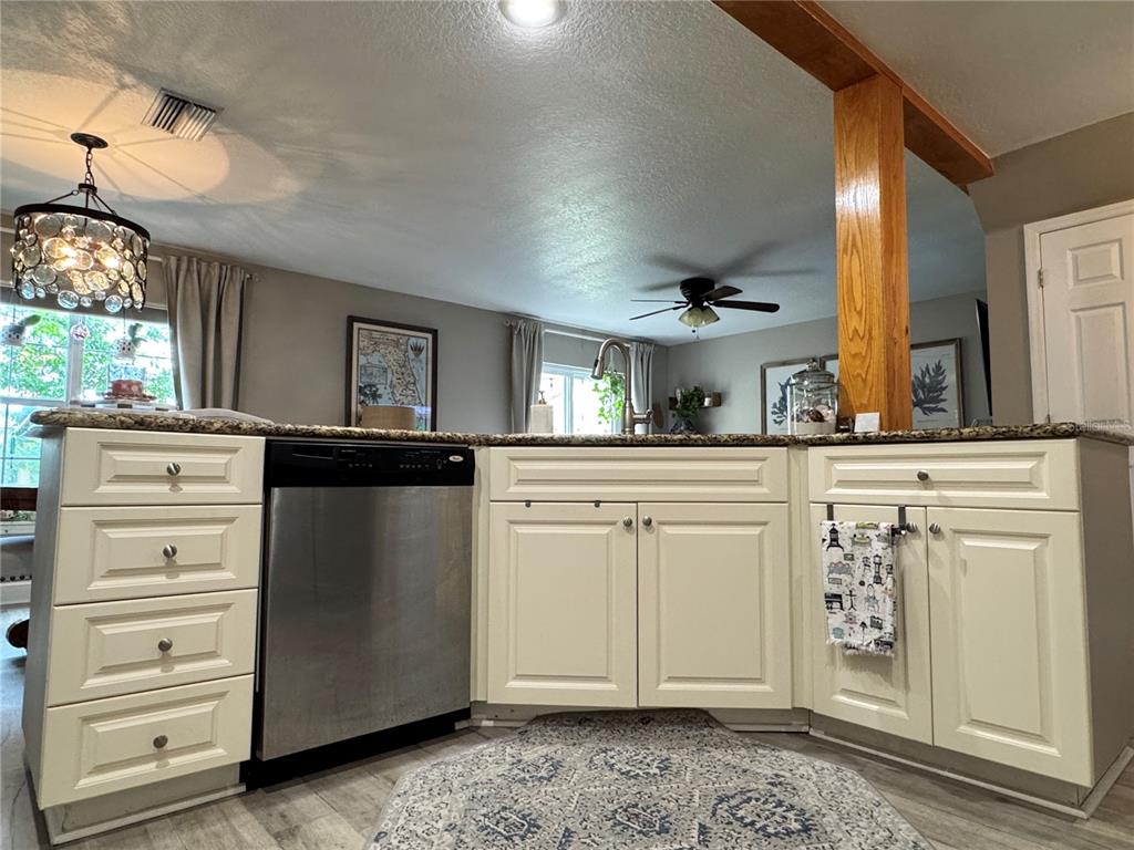 1116 Sunset Point Road, Unit 202 Clearwater, FL 33755 - Photo 14 of 31 a kitchen with white cabinets and sink