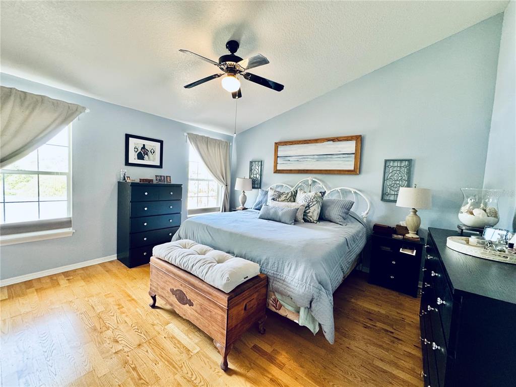 1116 Sunset Point Road, Unit 202 Clearwater, FL 33755 - Photo 17 of 31 a spacious bedroom with a bed and dresser