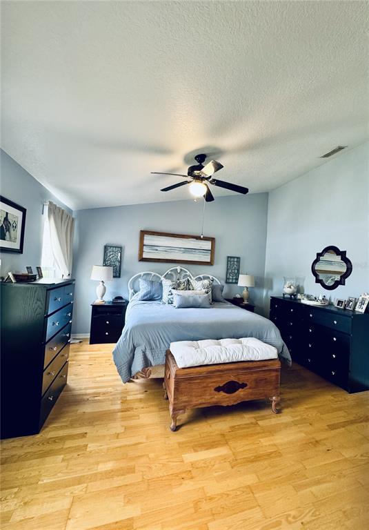 1116 Sunset Point Road, Unit 202 Clearwater, FL 33755 - Photo 18 of 31 a bedroom with a bed and lamp on dresser