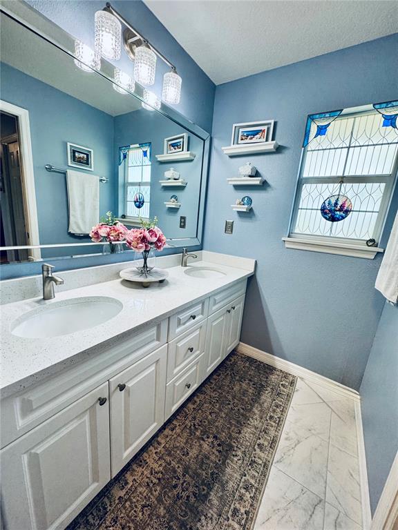 1116 Sunset Point Road, Unit 202 Clearwater, FL 33755 - Photo 19 of 31 a bathroom with a double vanity sink and a mirror