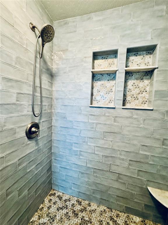 1116 Sunset Point Road, Unit 202 Clearwater, FL 33755 - Photo 20 of 31 a bathroom with a shower