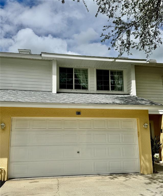 1116 Sunset Point Road, Unit 202 Clearwater, FL 33755 - Photo 2 of 31 a view of a house with a swimming pool