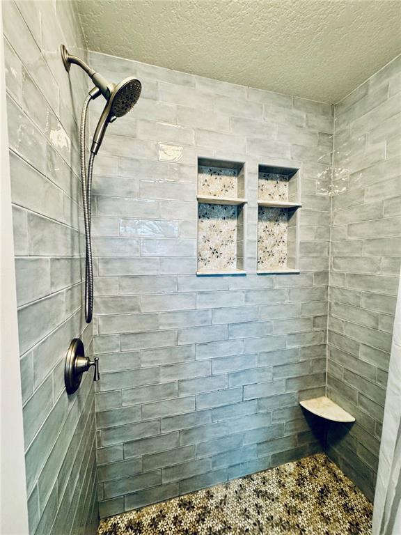 1116 Sunset Point Road, Unit 202 Clearwater, FL 33755 - Photo 21 of 31 a bathroom with a shower