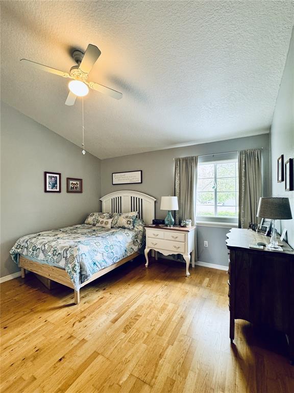 1116 Sunset Point Road, Unit 202 Clearwater, FL 33755 - Photo 22 of 31 a bedroom with a bed and a table in it