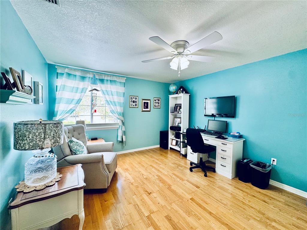 1116 Sunset Point Road, Unit 202 Clearwater, FL 33755 - Photo 23 of 31 a living room with furniture and a wooden floor