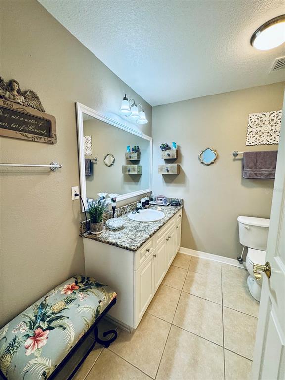 1116 Sunset Point Road, Unit 202 Clearwater, FL 33755 - Photo 25 of 31 a bathroom with a granite countertop sink and a mirror