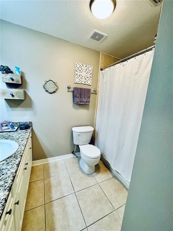 1116 Sunset Point Road, Unit 202 Clearwater, FL 33755 - Photo 26 of 31 a bathroom with a granite countertop sink and a mirror