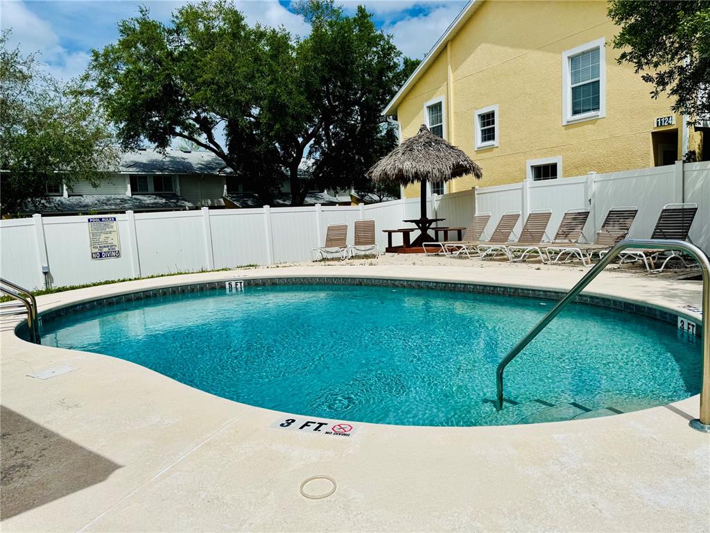 1116 Sunset Point Road, Unit 202 Clearwater, FL 33755 - Photo 31 of 31 a view of a house with a swimming pool