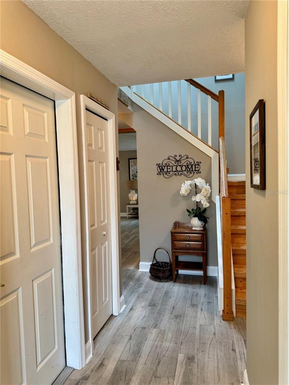 1116 Sunset Point Road, Unit 202 Clearwater, FL 33755 - Photo 4 of 31 a bedroom with furniture and wooden floor