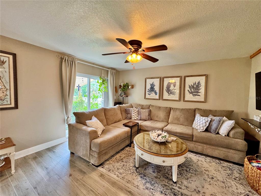1116 Sunset Point Road, Unit 202 Clearwater, FL 33755 - Photo 7 of 31 a living room with a couch and a large window