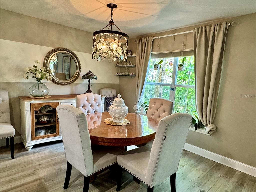 1116 Sunset Point Road, Unit 202 Clearwater, FL 33755 - Photo 9 of 31 a view of a dining room with furniture window and wooden floor