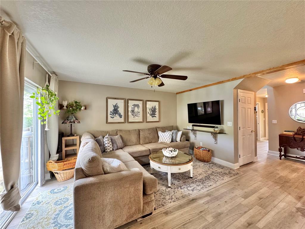 1116 Sunset Point Road, Unit 202 Clearwater, FL 33755 - Photo 10 of 31 a living room with furniture a flat screen tv and a large window