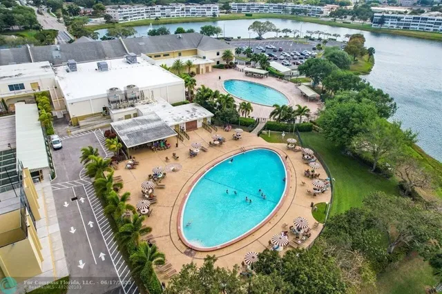 an aerial view of a swimming pool with outdoor space and lake view