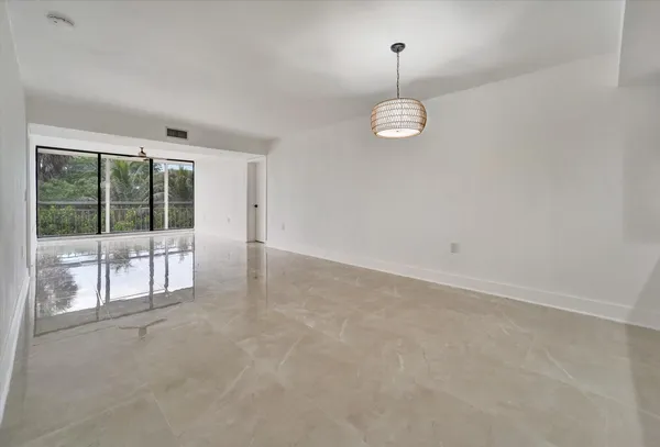 an empty room with windows and entrance