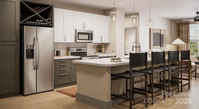 a kitchen with stainless steel appliances a refrigerator and a stove top oven