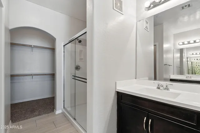 an empty room with a window and a ceiling fan