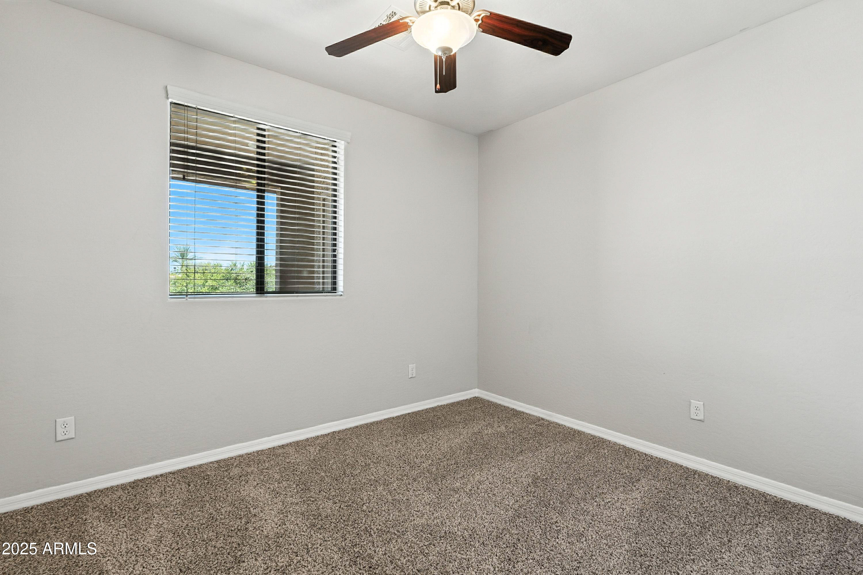 3330 South Gilbert Road, Unit 2066 Chandler, AZ 85286 - Photo 22 of 67 an empty room with a window and a ceiling fan