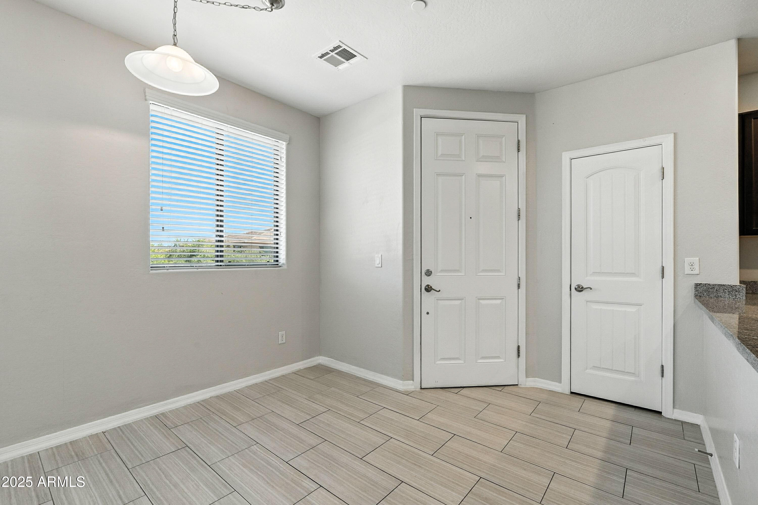 3330 South Gilbert Road, Unit 2066 Chandler, AZ 85286 - Photo 2 of 67 a view of an empty room with a window