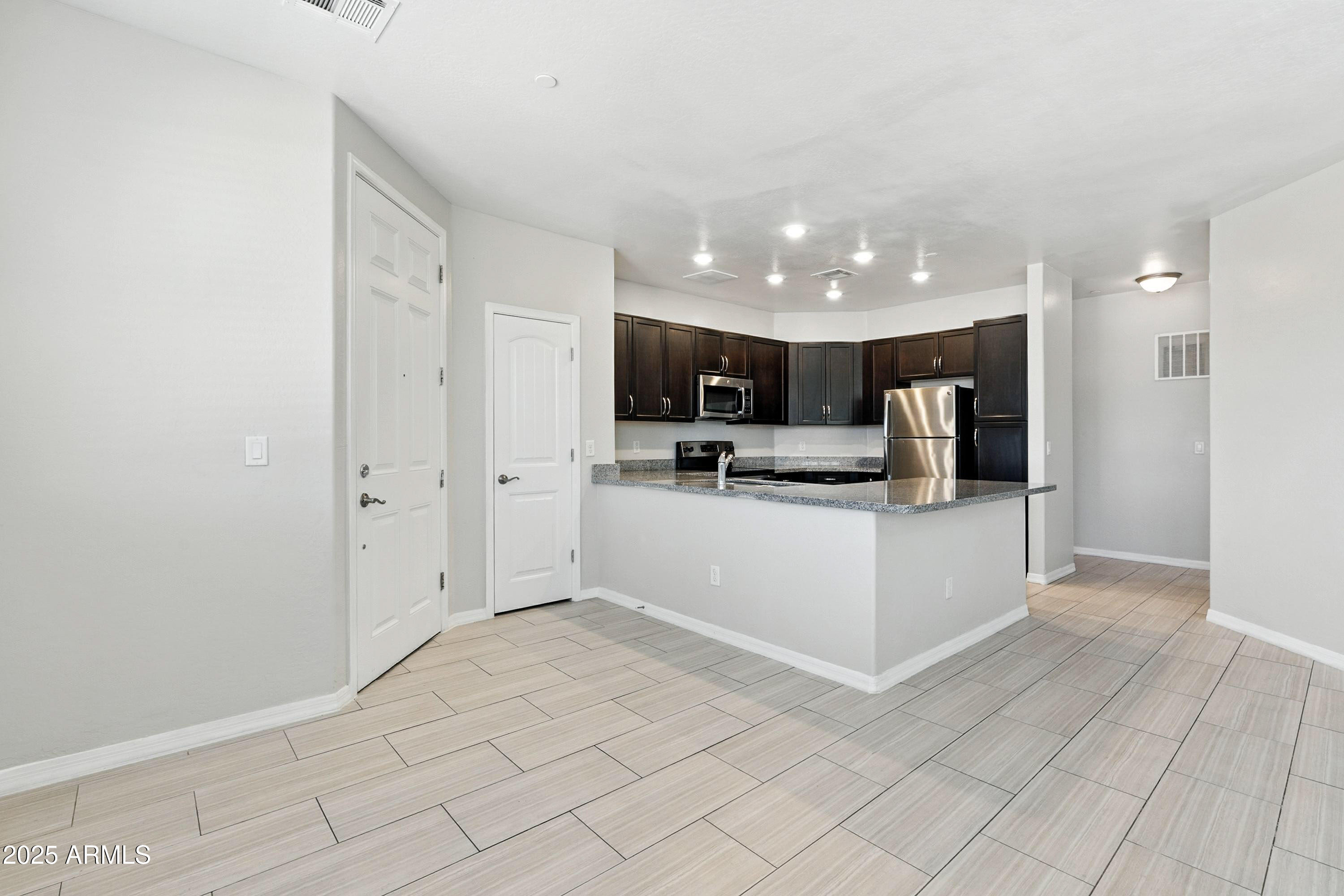 3330 South Gilbert Road, Unit 2066 Chandler, AZ 85286 - Photo 3 of 67 a view of kitchen with refrigerator cabinets and microwave