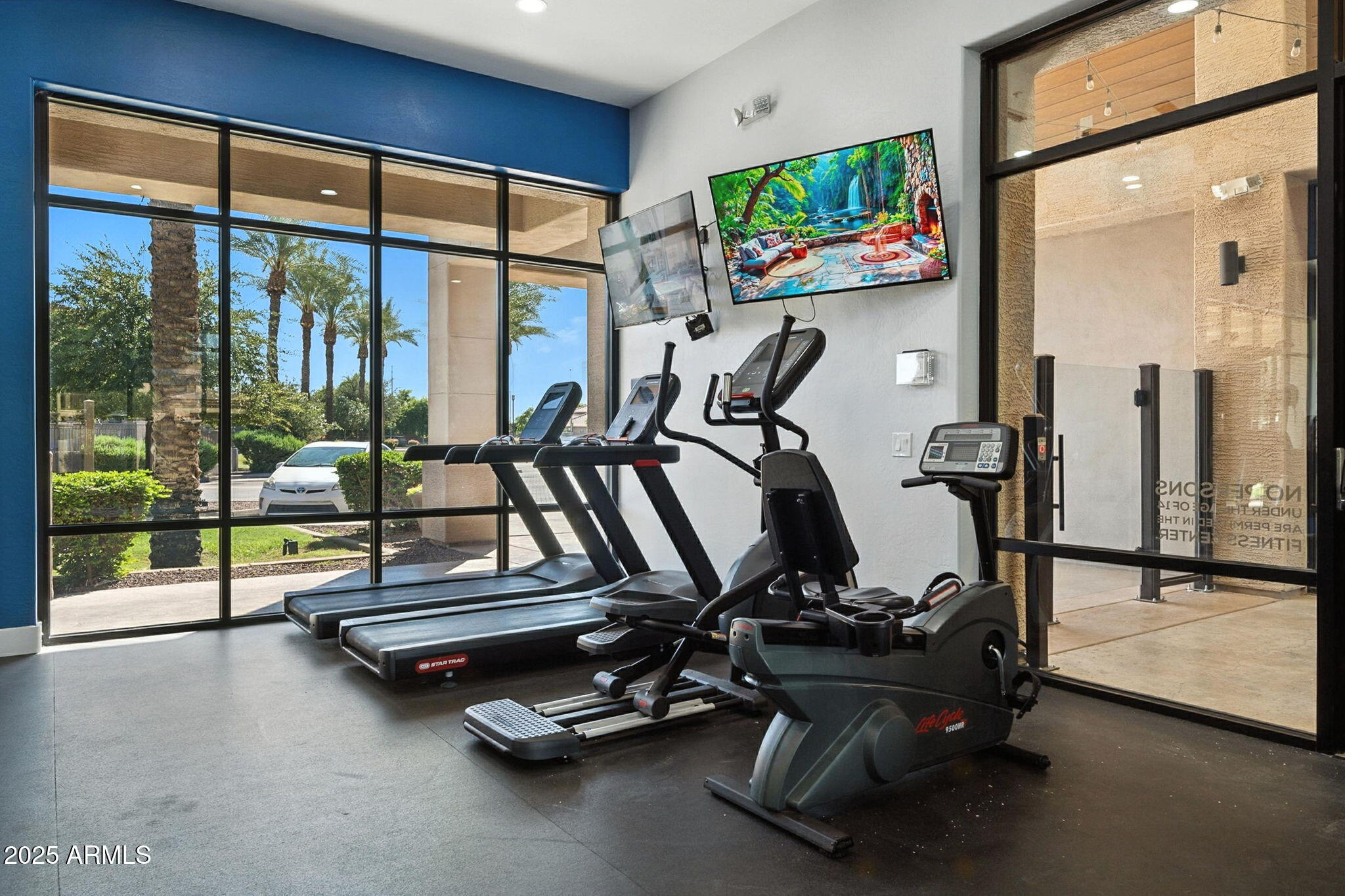 3330 South Gilbert Road, Unit 2066 Chandler, AZ 85286 - Photo 49 of 67 a room with gym equipment and large windows