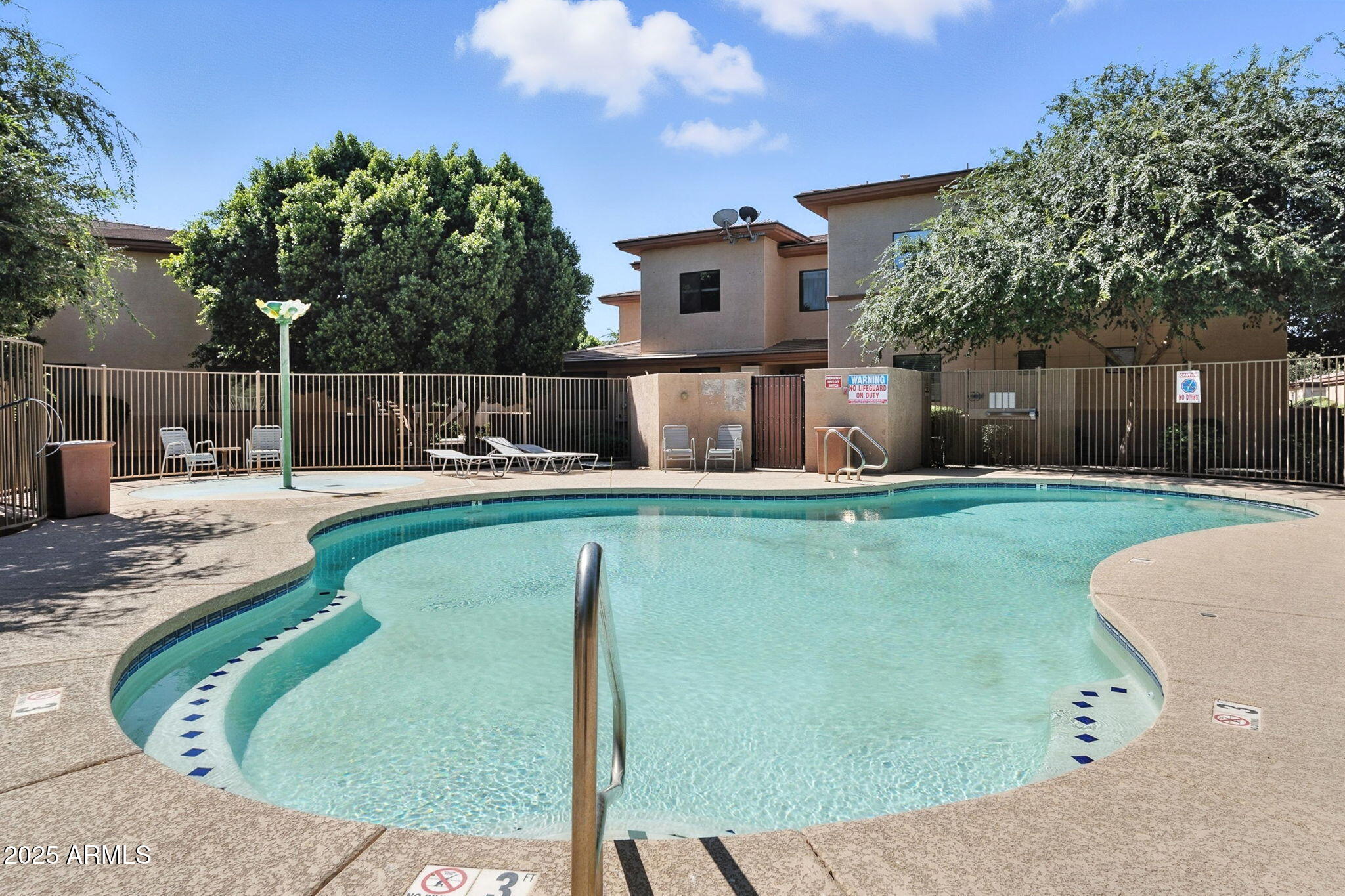3330 South Gilbert Road, Unit 2066 Chandler, AZ 85286 - Photo 57 of 67 a swimming pool with outdoor seating and yard in the back