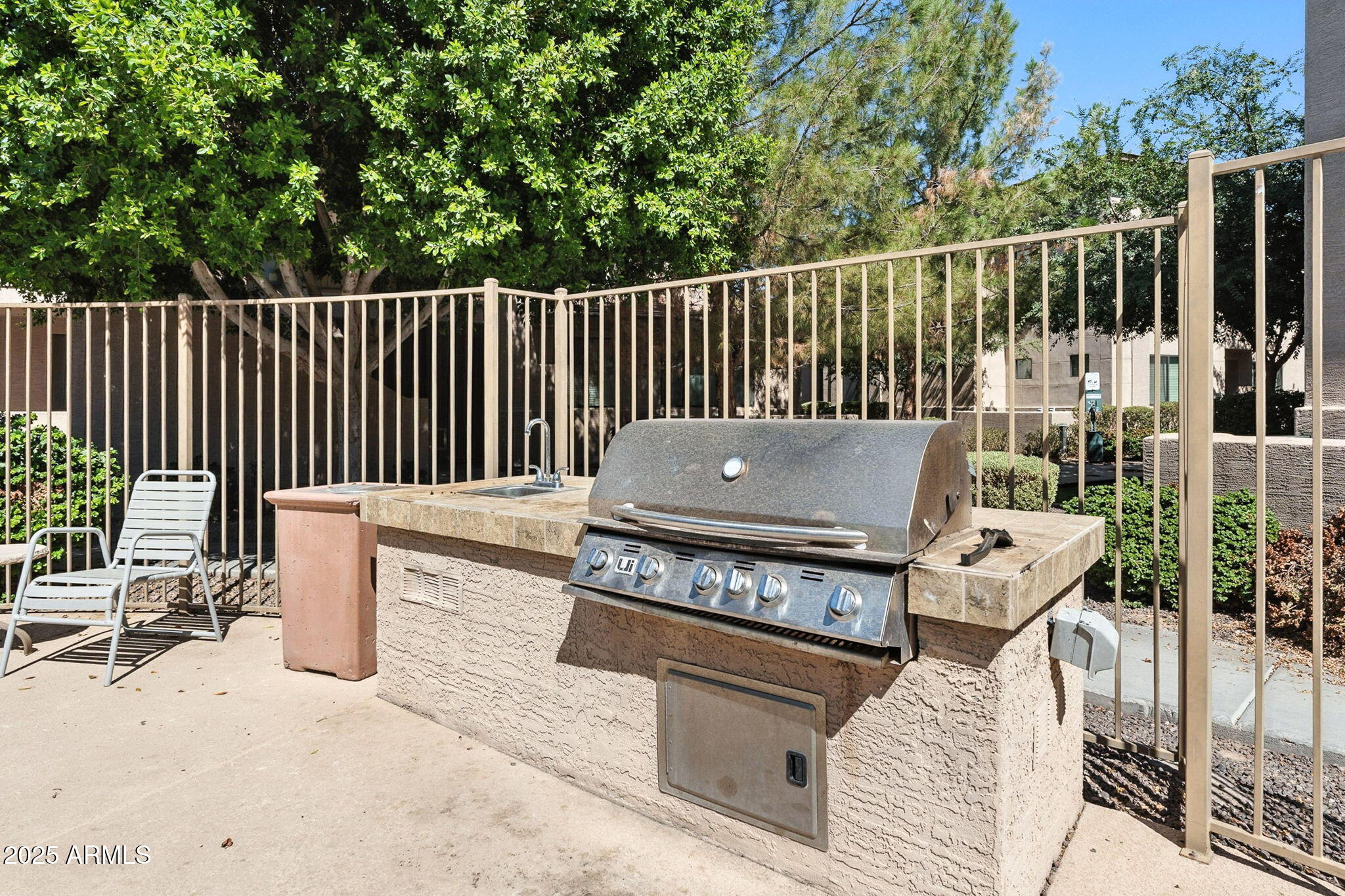 3330 South Gilbert Road, Unit 2066 Chandler, AZ 85286 - Photo 58 of 67 a roof deck with couches and wooden fence