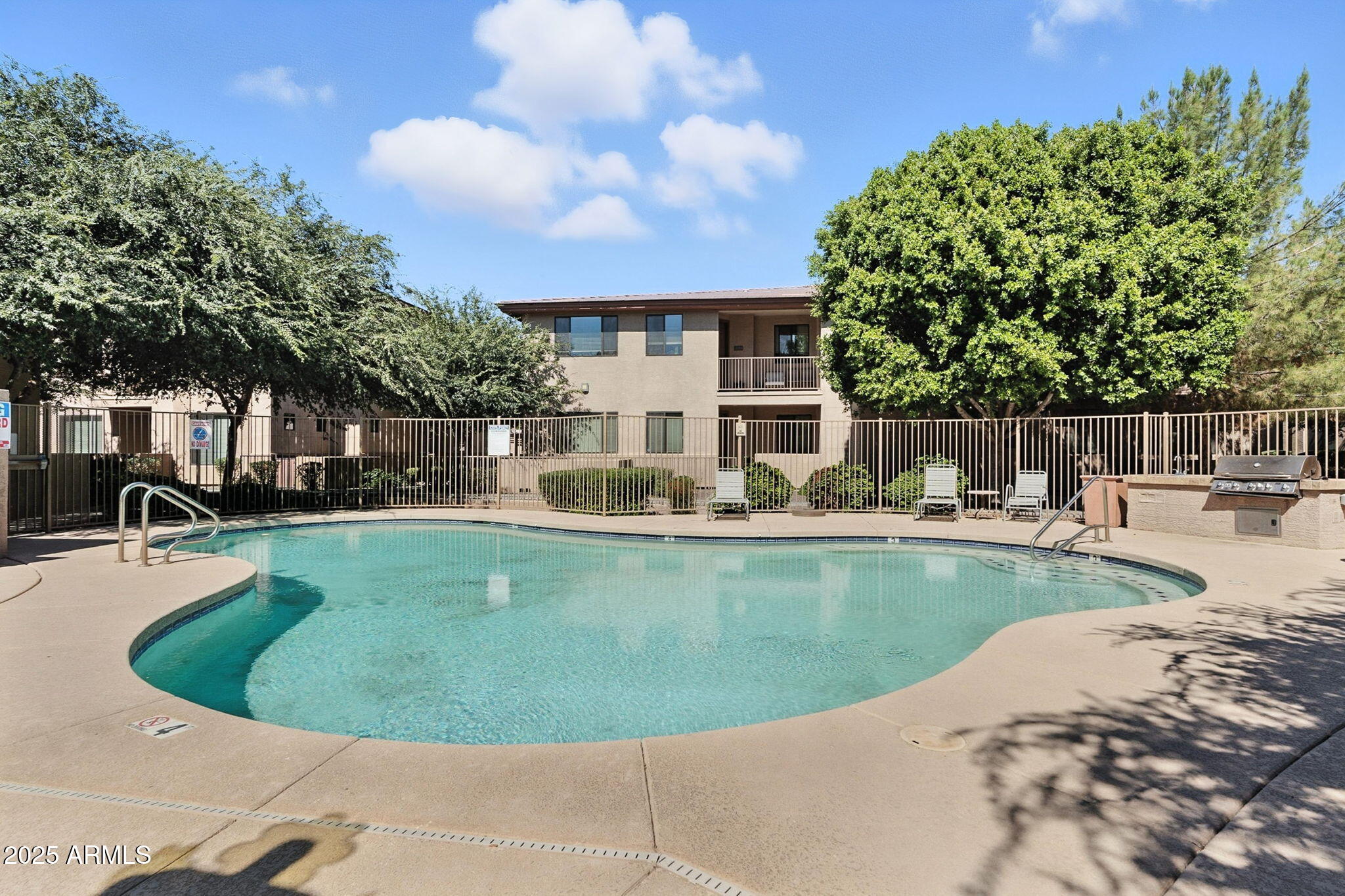 3330 South Gilbert Road, Unit 2066 Chandler, AZ 85286 - Photo 59 of 67 a view of a swimming pool with a sitting space