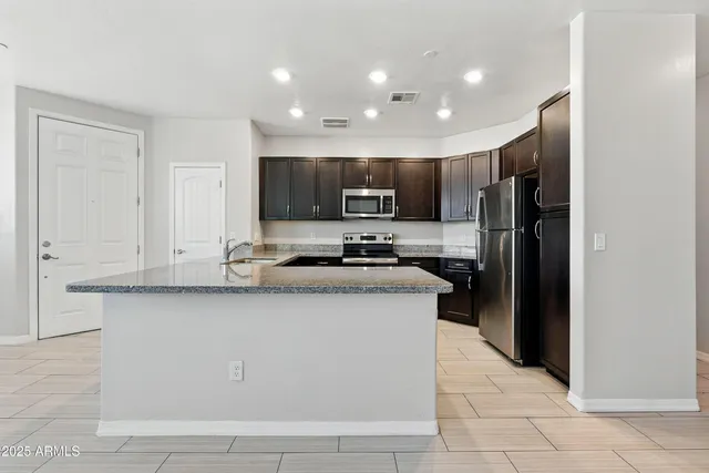 a kitchen with stainless steel appliances a sink stove and microwave