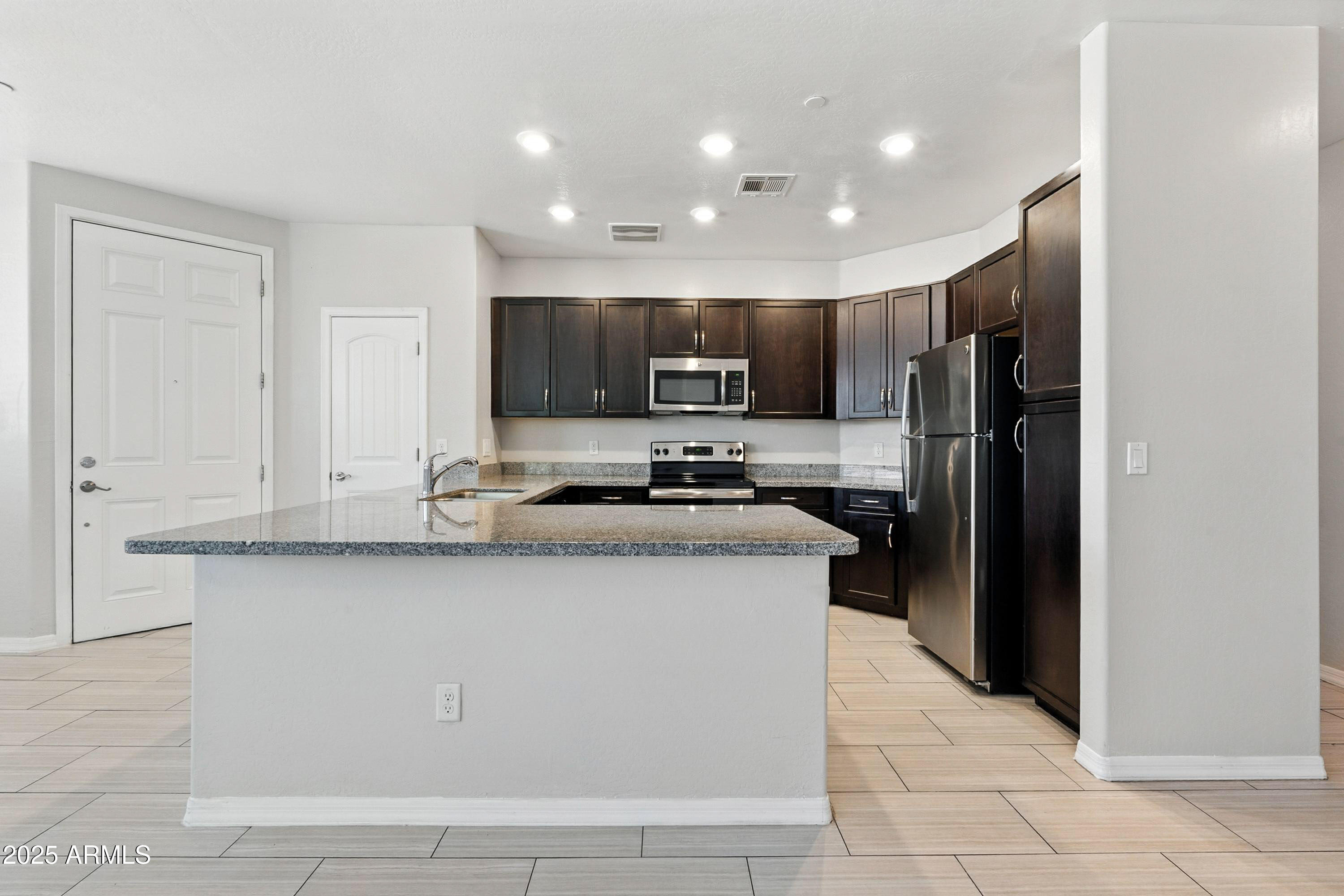 3330 South Gilbert Road, Unit 2066 Chandler, AZ 85286 - Photo 8 of 67 a kitchen with stainless steel appliances granite countertop a refrigerator stove microwave and cabinets