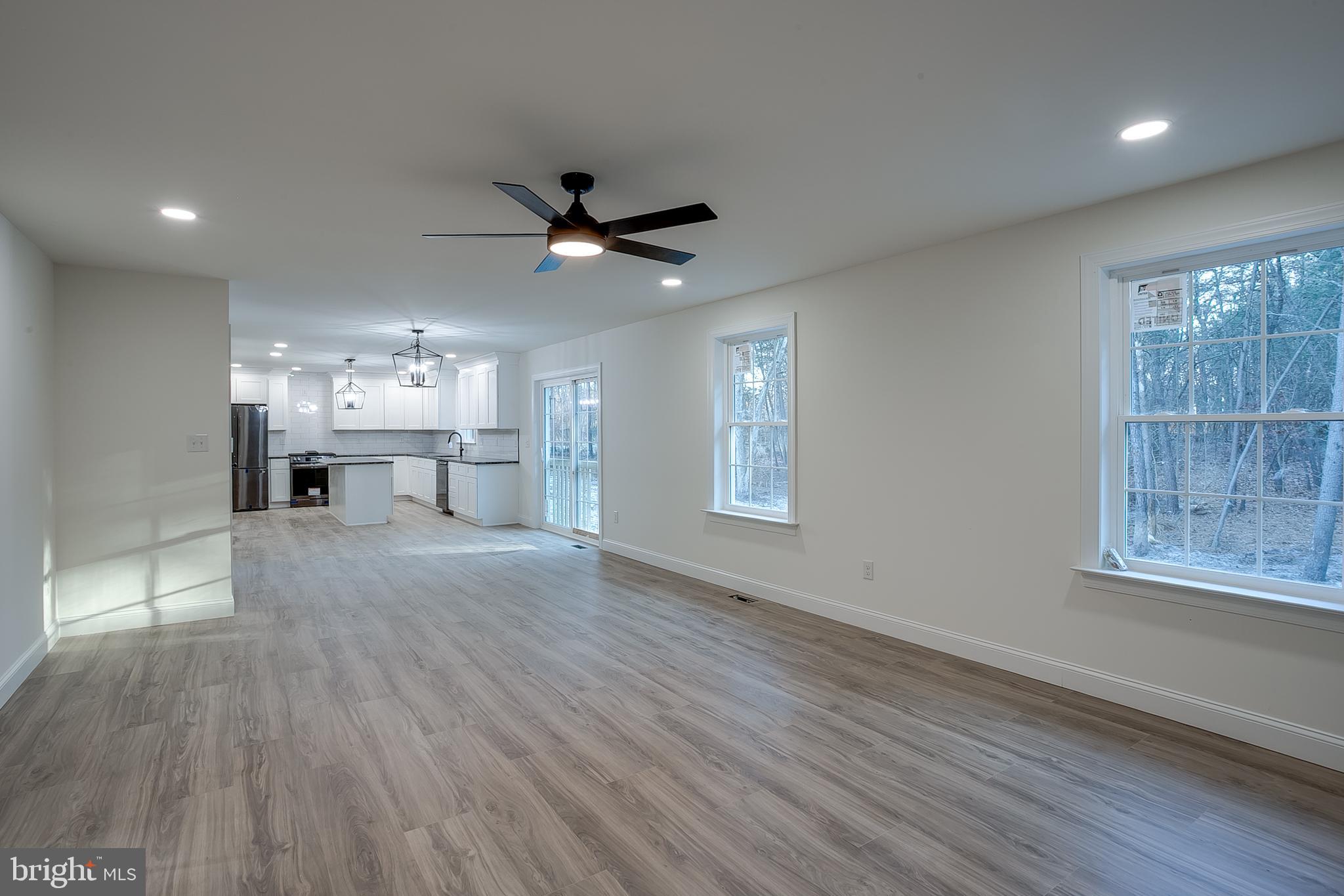 1427 Williamstown Erial Road Sicklerville, NJ 08081 - Photo 16 of 27 a view of a big room with wooden floor and a kitchen