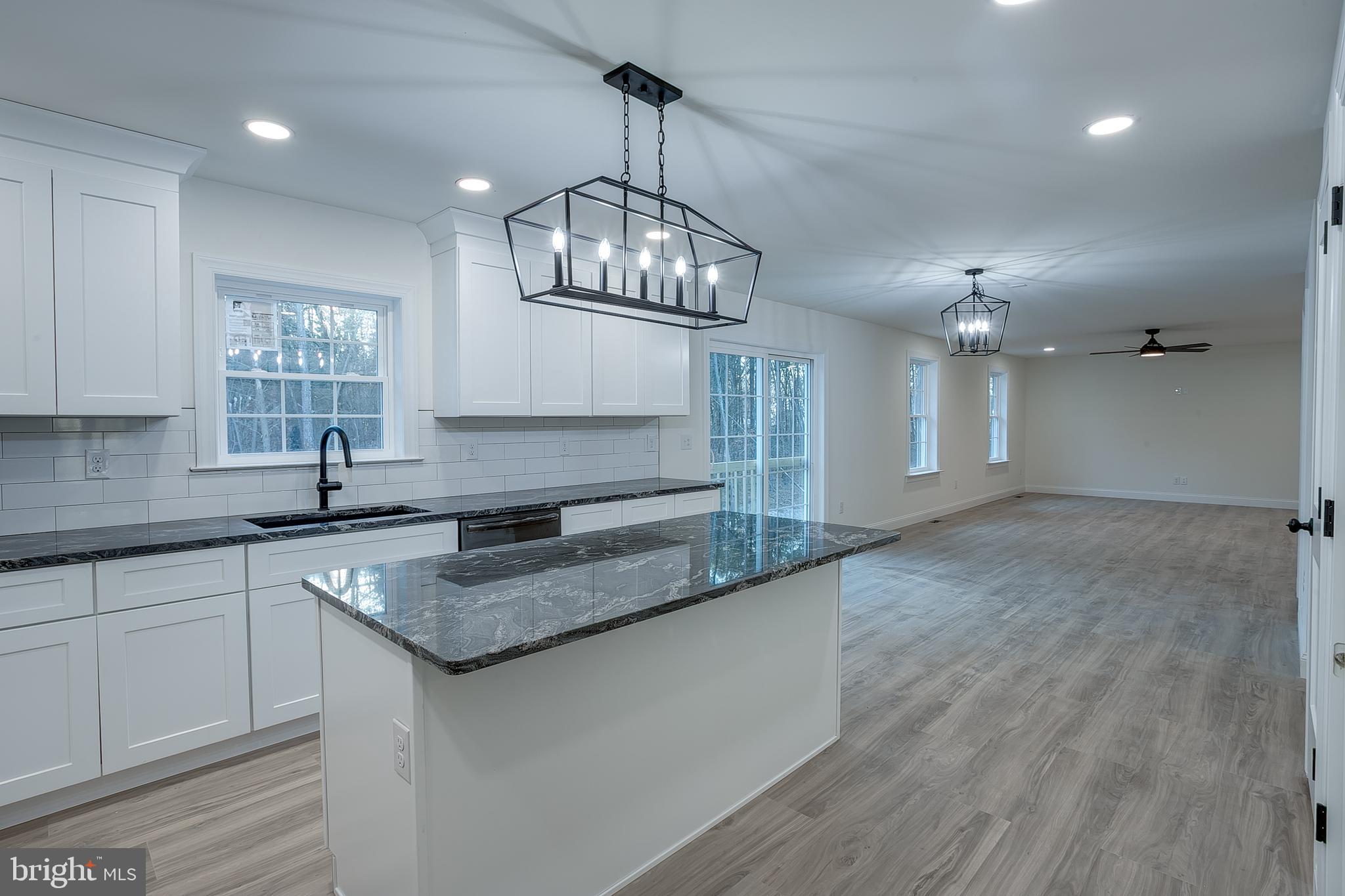 1427 Williamstown Erial Road Sicklerville, NJ 08081 - Photo 10 of 27 a kitchen with stainless steel appliances granite countertop a sink dishwasher a stove a dining table and chairs with wooden floor
