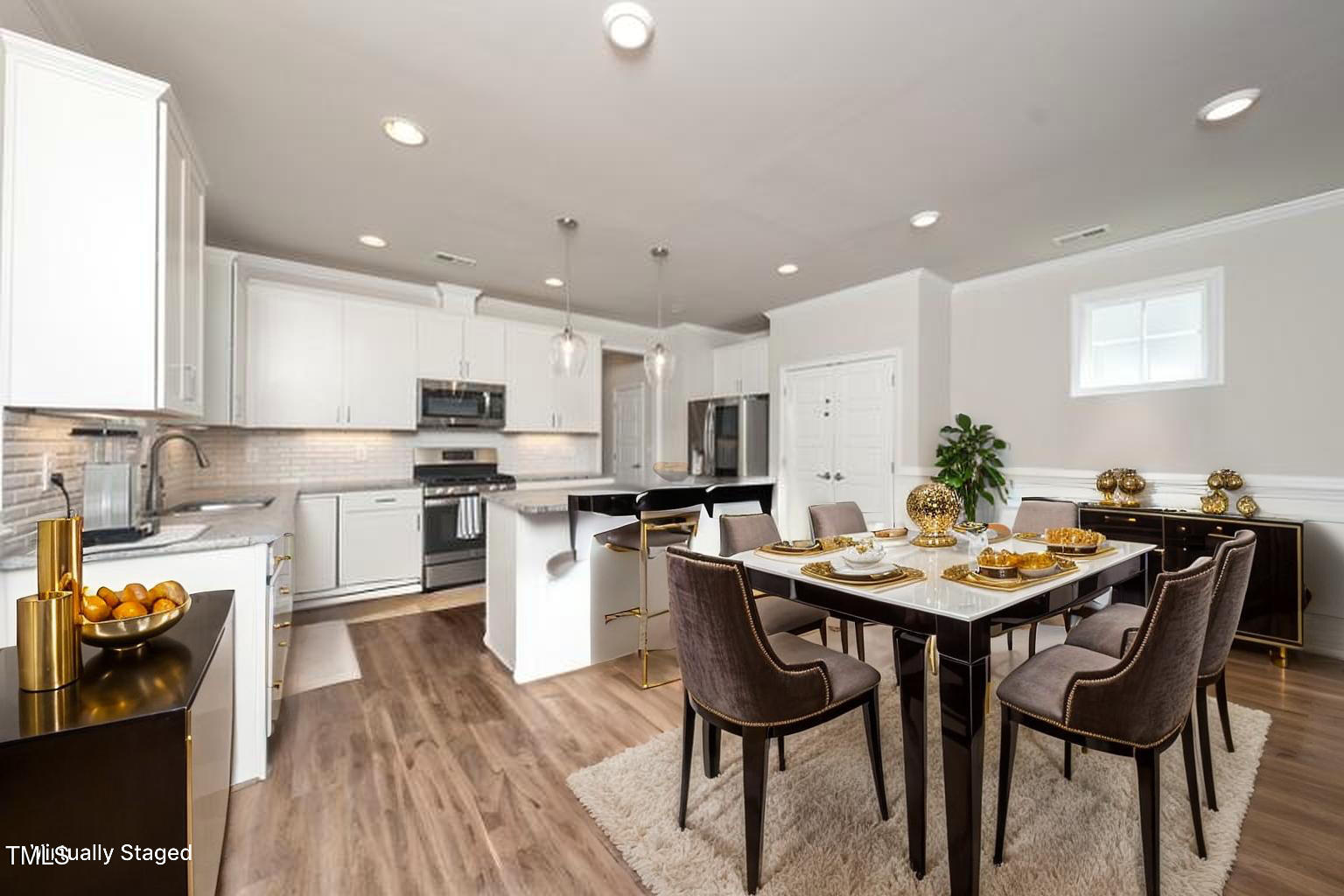 1705 Main Divide Drive Wake Forest, NC 27587 - Photo 10 of 47 a kitchen with stainless steel appliances kitchen island granite countertop a table chairs and a refrigerator