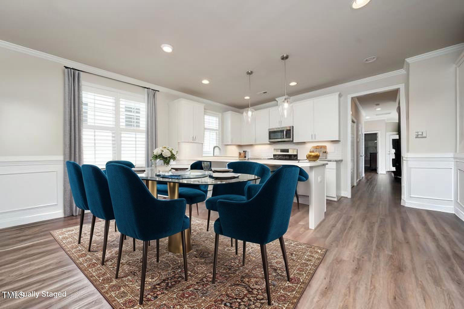 1705 Main Divide Drive Wake Forest, NC 27587 - Photo 13 of 47 a open dining room with stainless steel appliances granite countertop a stove a sink a refrigerator with a dining table and chairs