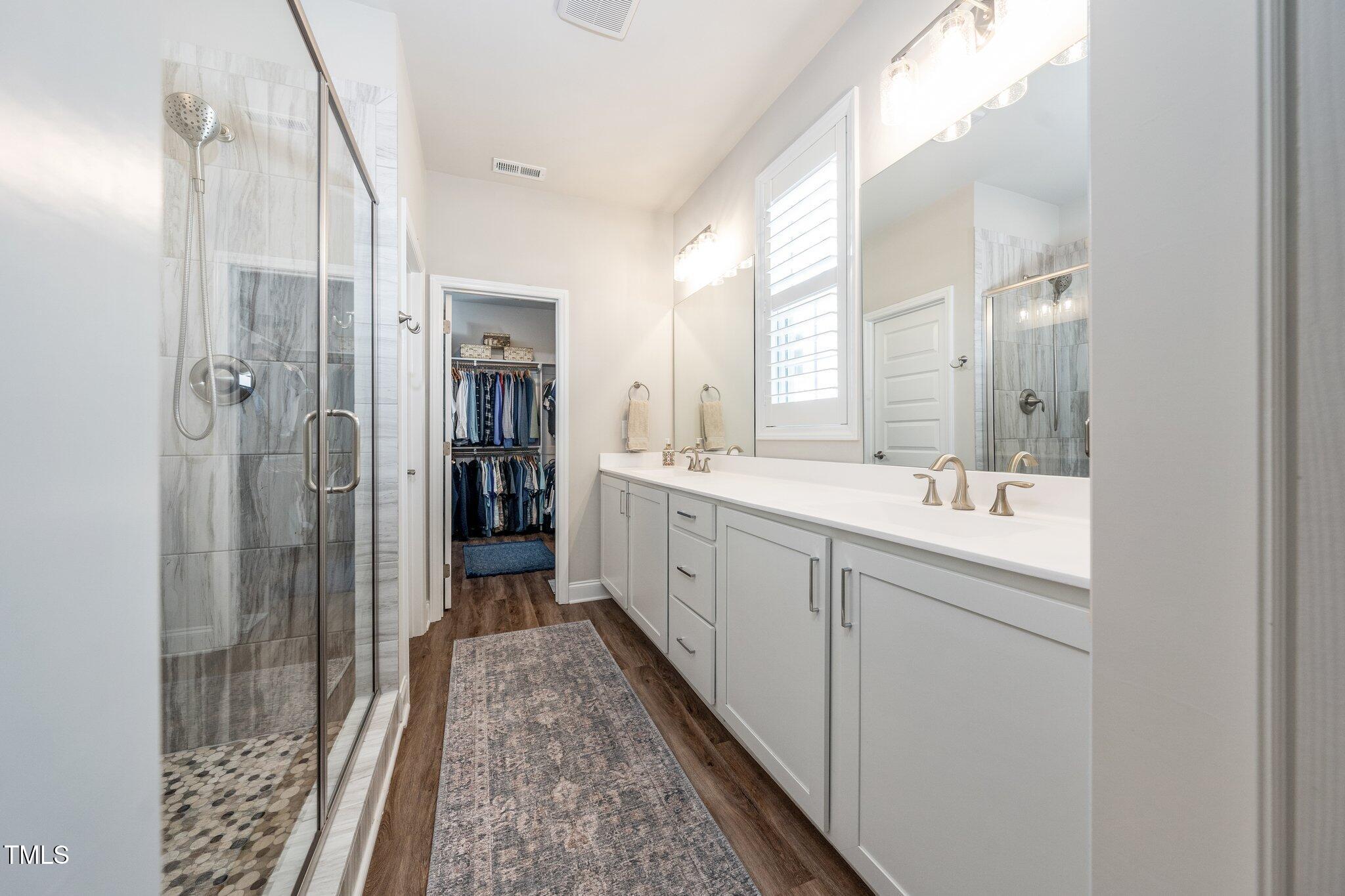 1705 Main Divide Drive Wake Forest, NC 27587 - Photo 19 of 47 a bathroom with a double vanity sink and a mirror