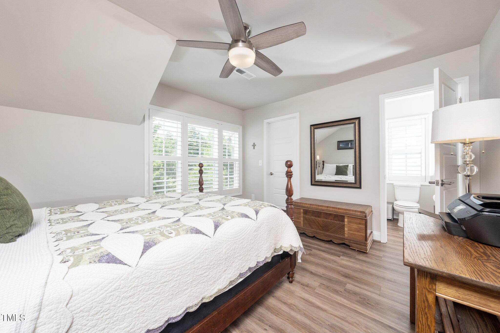 1705 Main Divide Drive Wake Forest, NC 27587 - Photo 29 of 47 a bedroom with a bed wooden floor and a fireplace