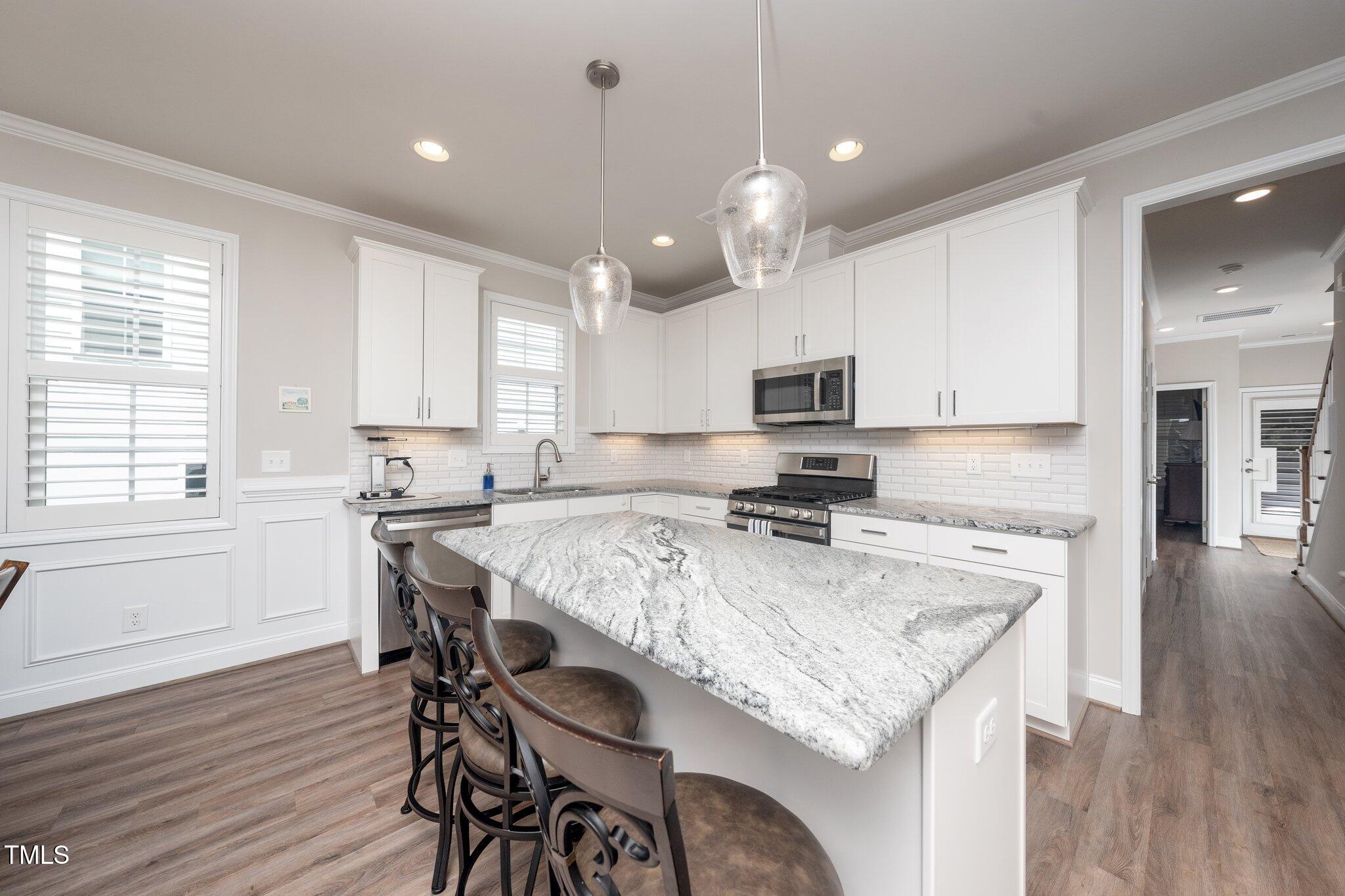 1705 Main Divide Drive Wake Forest, NC 27587 - Photo 5 of 47 a kitchen with a stove a refrigerator and a microwave