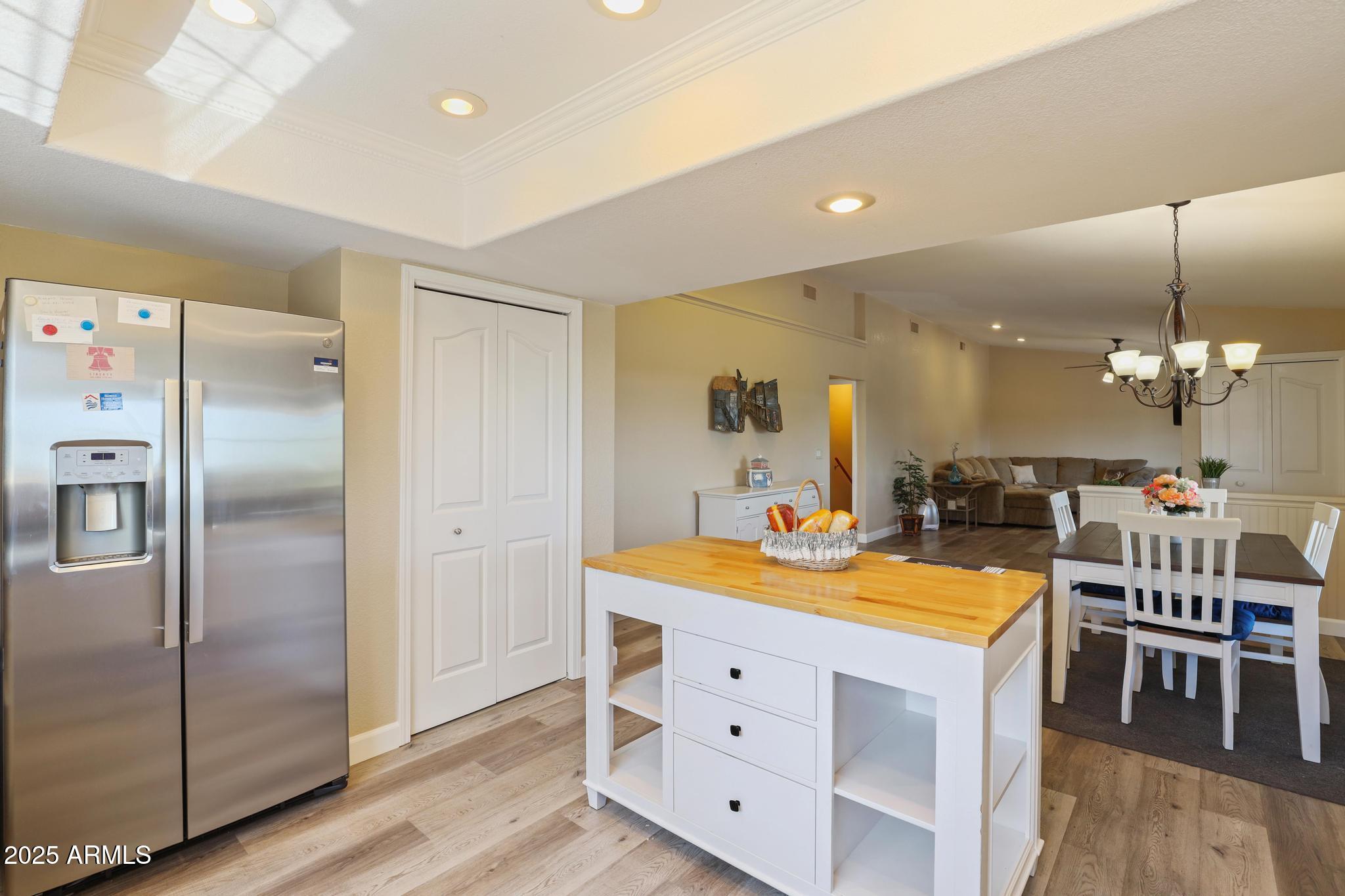 1101 North Monte Rosa Lane Payson, AZ 85541 - Photo 12 of 35 a kitchen with a refrigerator a sink and a dining table