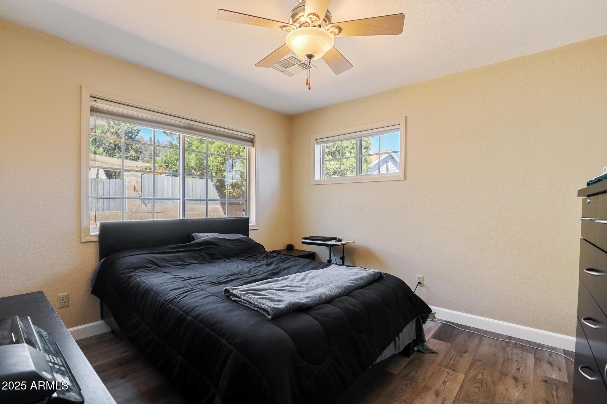 1101 North Monte Rosa Lane Payson, AZ 85541 - Photo 20 of 35 a bedroom with a bed and a chandelier