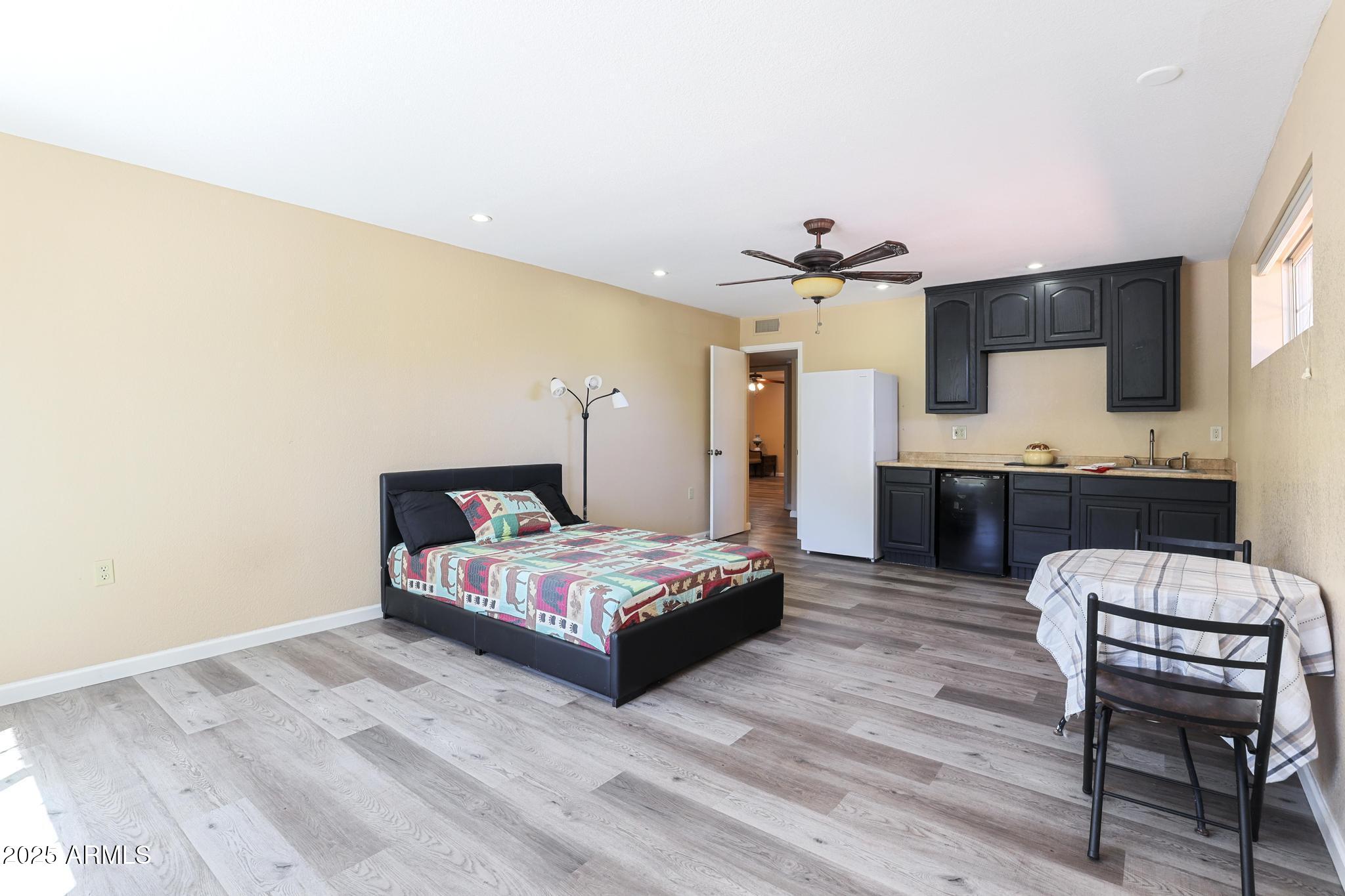 1101 North Monte Rosa Lane Payson, AZ 85541 - Photo 23 of 35 a bedroom with a bed and a chair