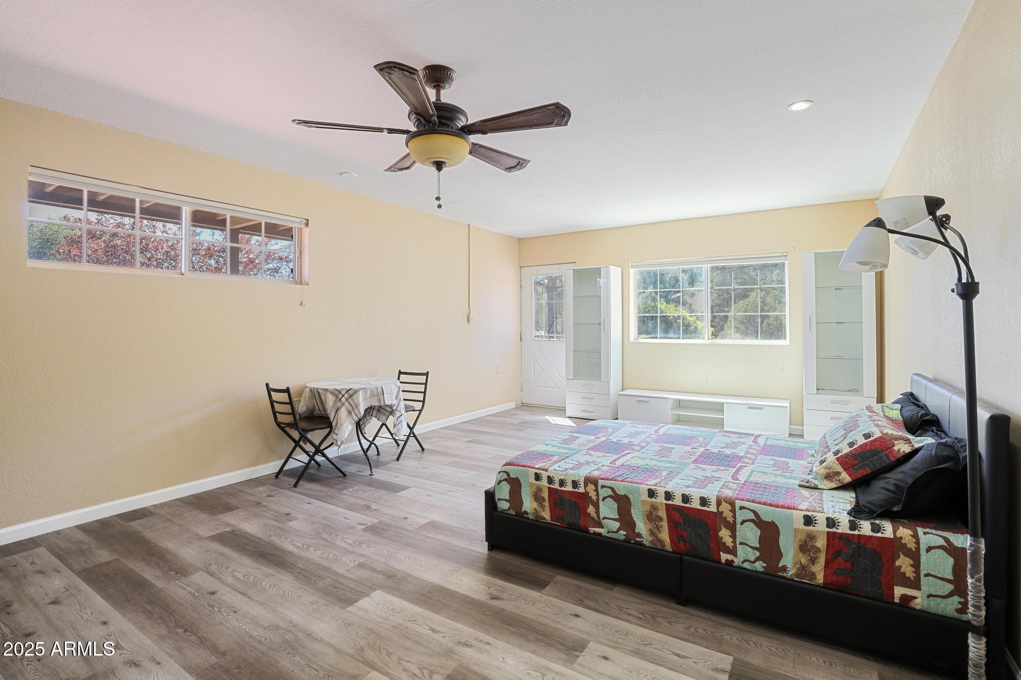 1101 North Monte Rosa Lane Payson, AZ 85541 - Photo 24 of 35 a bedroom with a bed and wooden floor