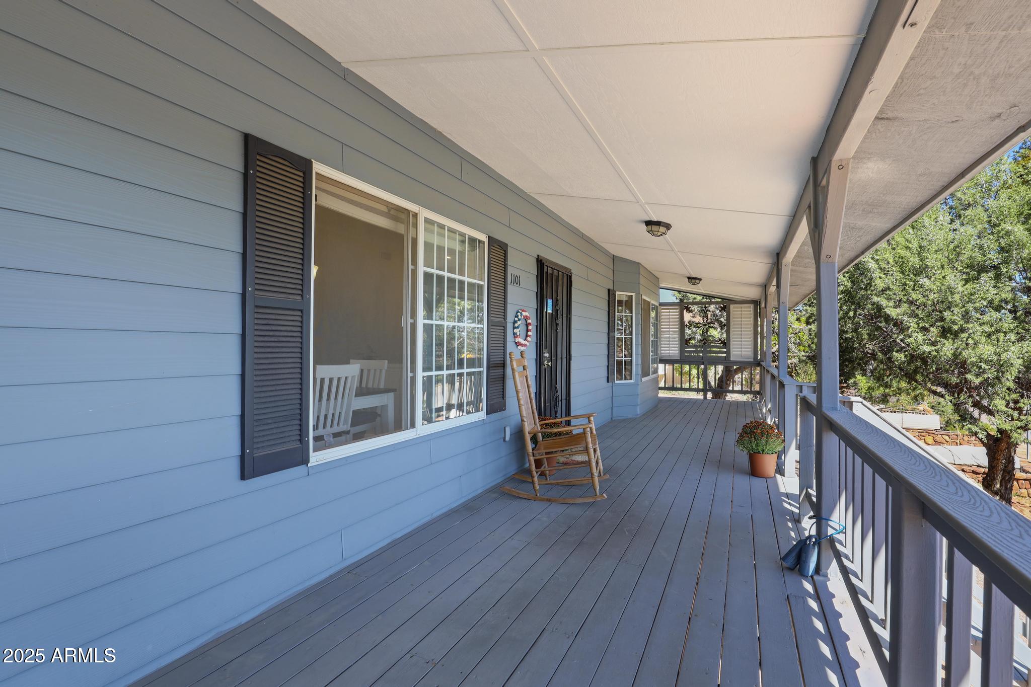 1101 North Monte Rosa Lane Payson, AZ 85541 - Photo 5 of 35 a view of a porch with wooden floor and iron fence