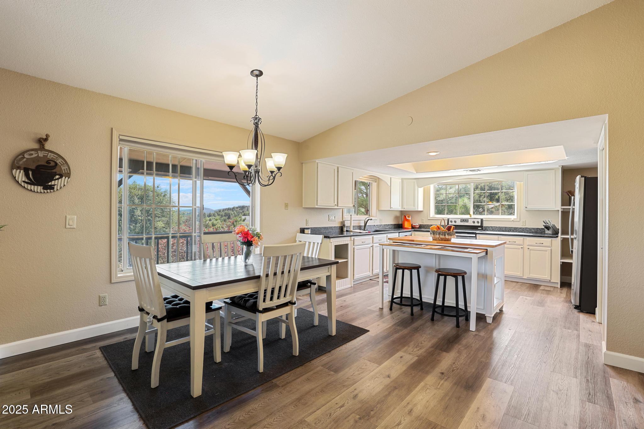 1101 North Monte Rosa Lane Payson, AZ 85541 - Photo 8 of 35 a dining room with furniture a chandelier and wooden floor