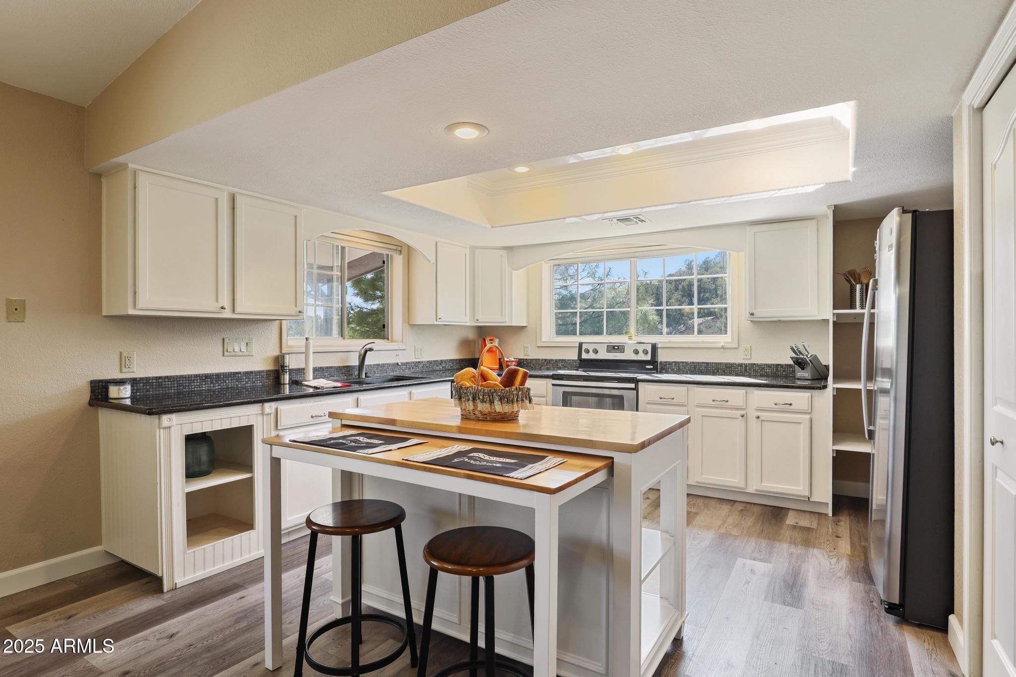 1101 North Monte Rosa Lane Payson, AZ 85541 - Photo 9 of 35 a kitchen with kitchen island a stove a table and chairs in it