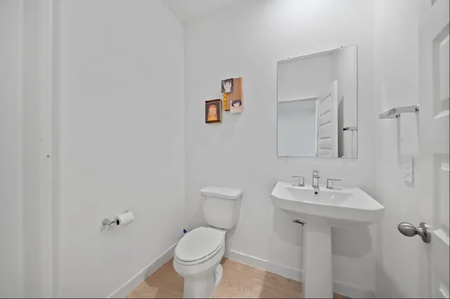 a view of a yard in front of a house with a large tree